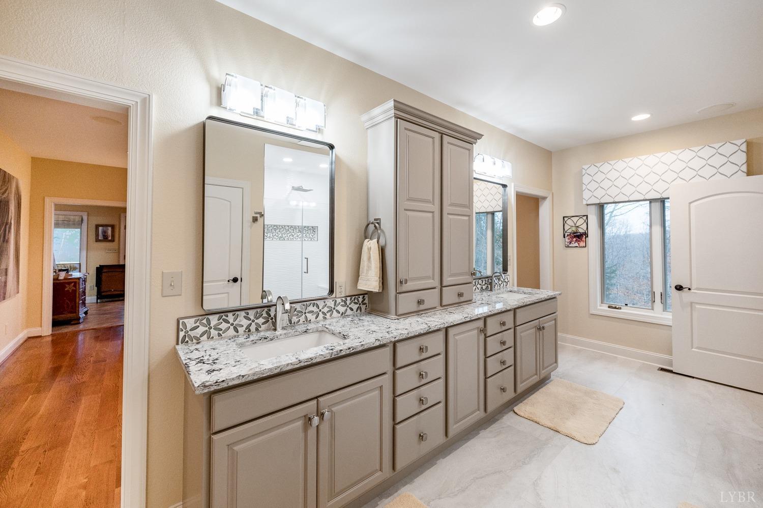 657 Cherry Hill Road Amherst, VA 24521 - Photo 34 of 91 a spacious bathroom with a granite countertop double vanity sink a mirror and a shower