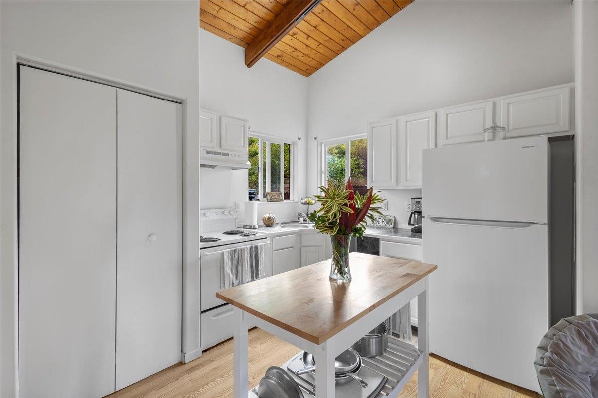 10 Poko Way, Unit B Haiku, HI 96708 - Photo 13 of 37 a kitchen with stainless steel appliances granite countertop a sink a refrigerator and a stove