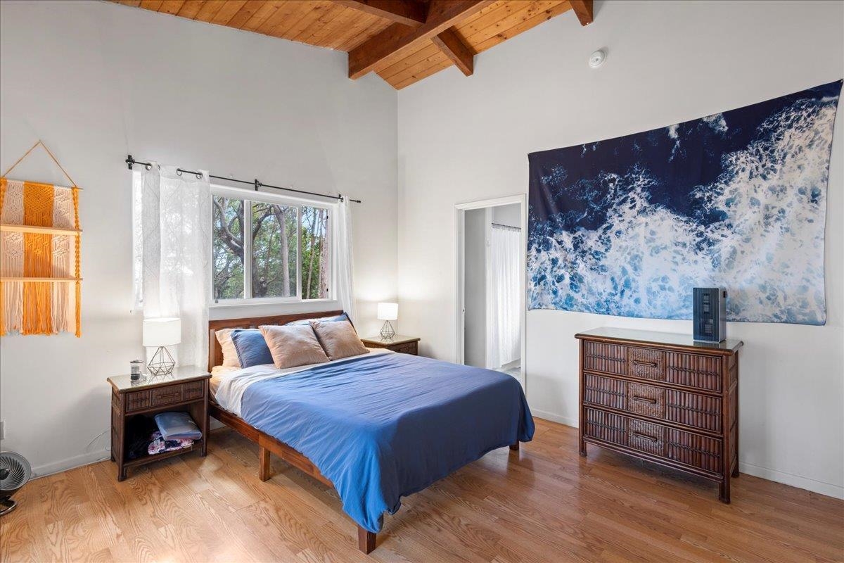 10 Poko Way, Unit B Haiku, HI 96708 - Photo 18 of 37 a bedroom with a bed and a dresser next to a window