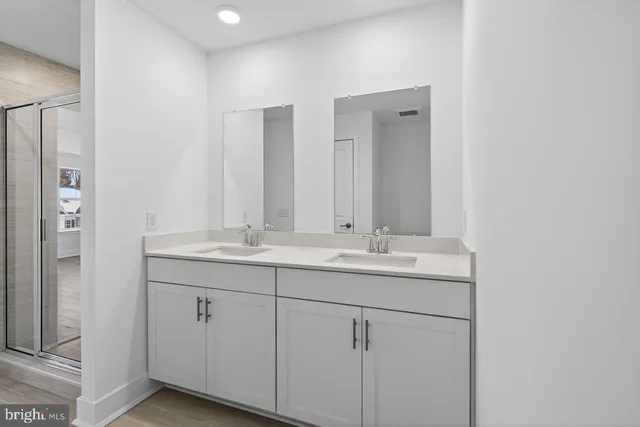 a bathroom with double sink and mirror