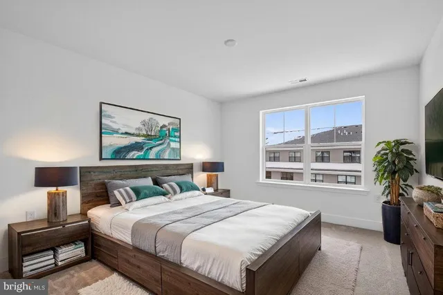 a bedroom with a large bed and a window