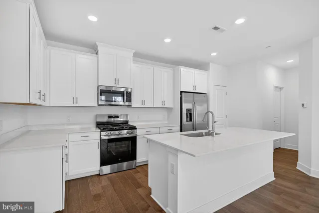 a kitchen that has a sink and a stove in it