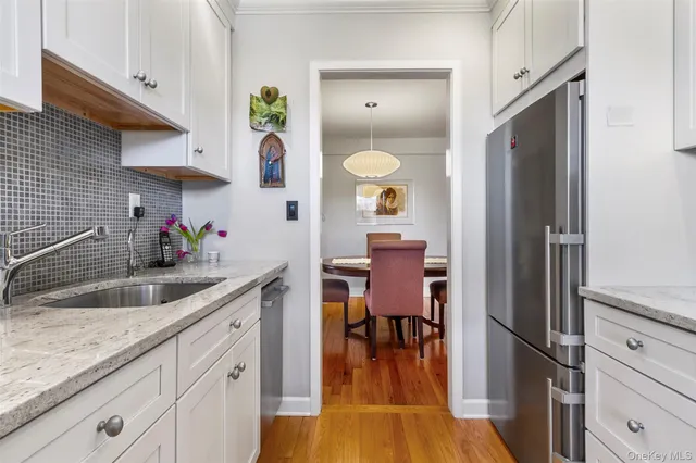 a kitchen with a sink cabinets and wooden floor