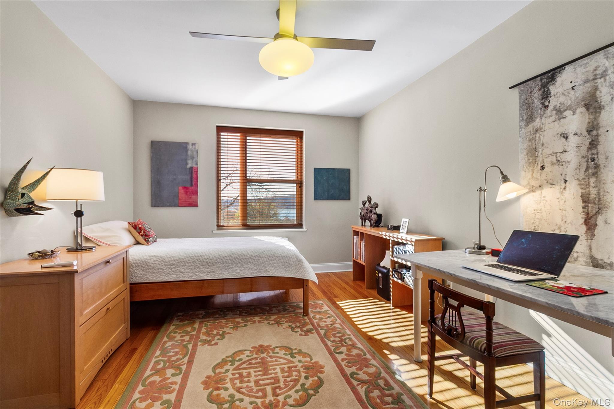 565 Broadway, Unit 4A Hastings-on-Hudson, NY 10706 - Photo 14 of 19 a bedroom with a bed and a chandelier