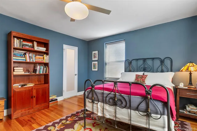 a bedroom with furniture and a book shelf