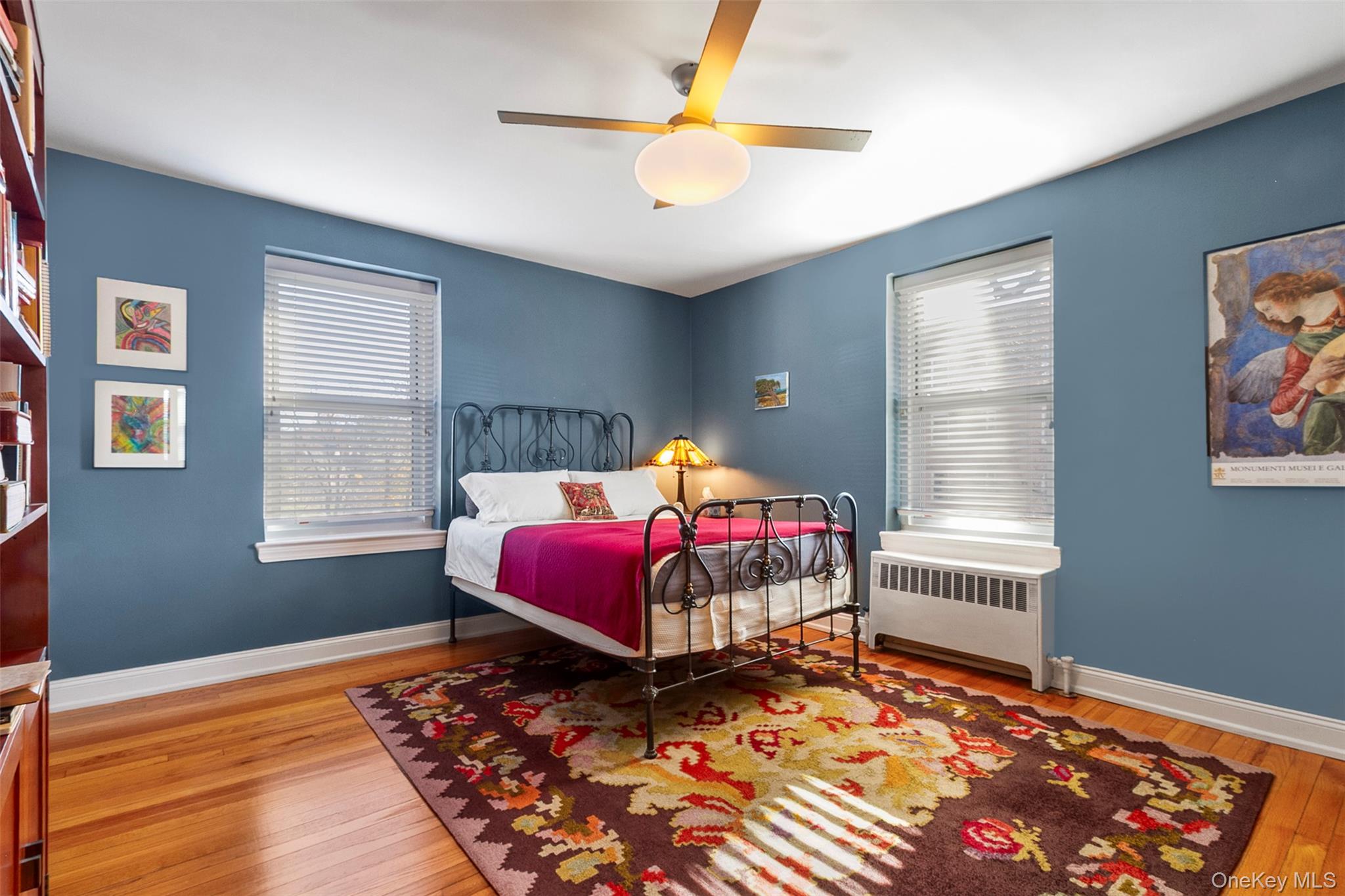 565 Broadway, Unit 4A Hastings-on-Hudson, NY 10706 - Photo 18 of 19 a bedroom with a bed and wooden floor