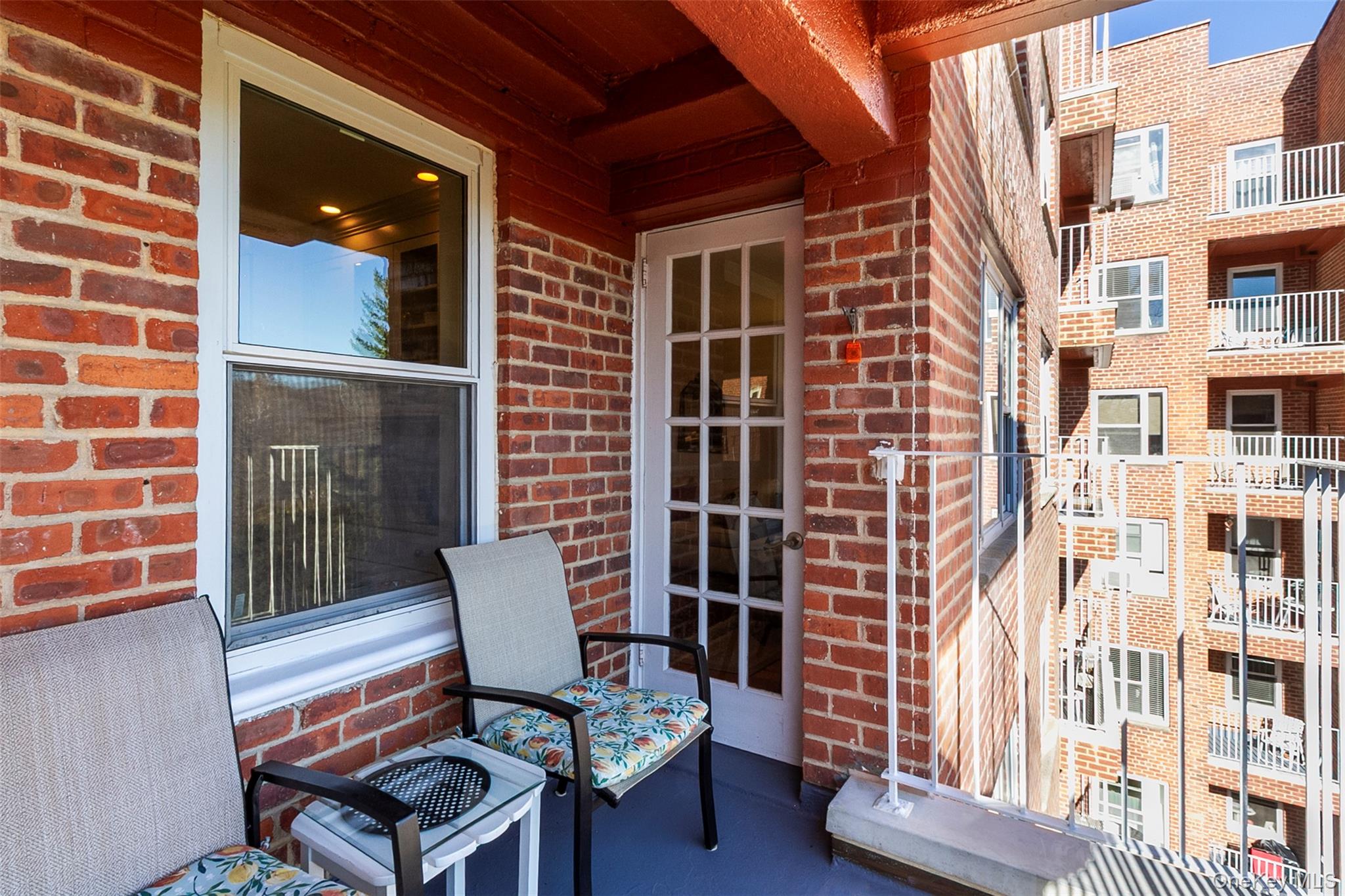 565 Broadway, Unit 4A Hastings-on-Hudson, NY 10706 - Photo 19 of 19 a view of a chair and table in the back yard of a building