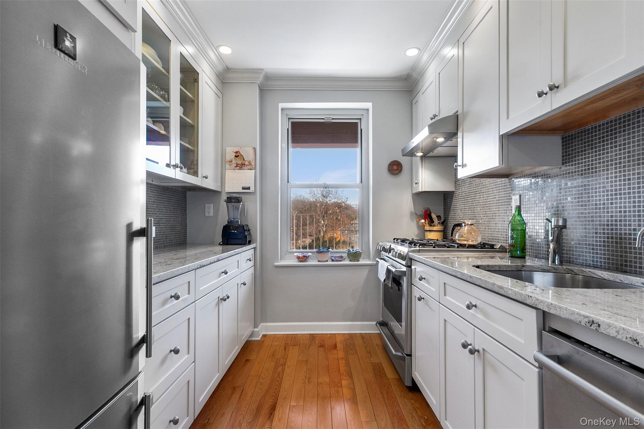 565 Broadway, Unit 4A Hastings-on-Hudson, NY 10706 - Photo 10 of 19 a kitchen with stainless steel appliances granite countertop a stove sink and cabinets