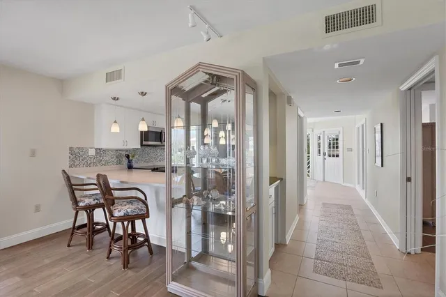 an aerial view of a house with a garden and lake view