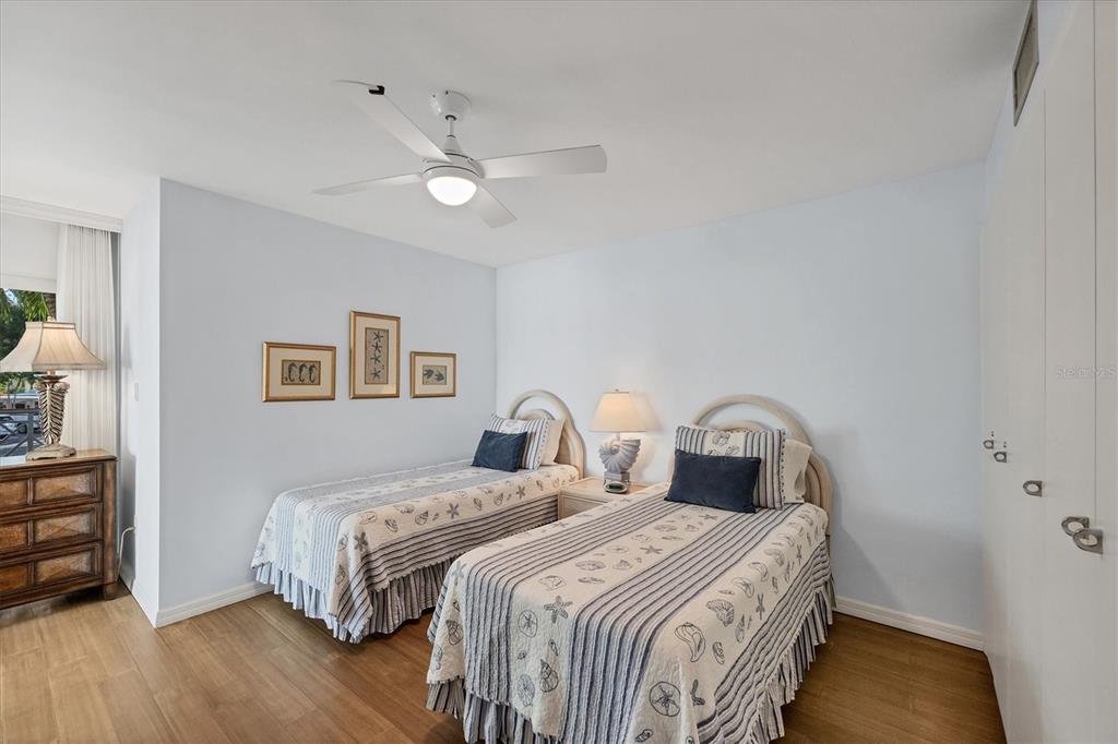 11000 Placida Road, Unit 702 Placida, FL 33946 - Photo 23 of 60 a bedroom with a bed and a chandelier