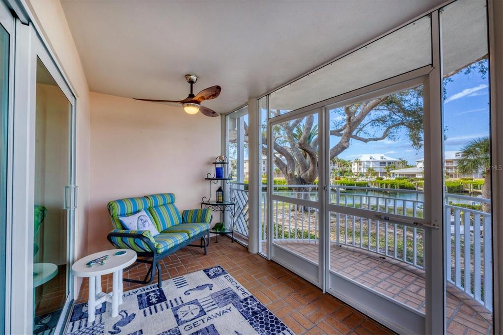 11000 Placida Road, Unit 702 Placida, FL 33946 - Photo 29 of 60 a living room with furniture and a floor to ceiling window