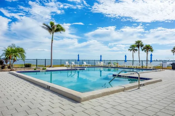 a view of a swimming pool with outdoor seating