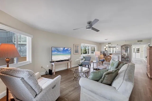 a living room with furniture and a floor to ceiling window