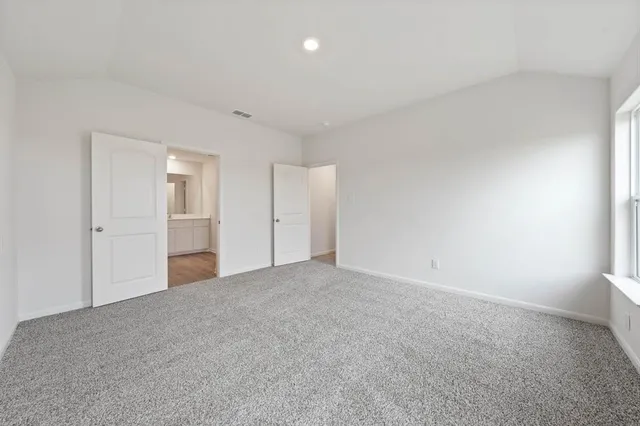 a view of an empty room and closet area