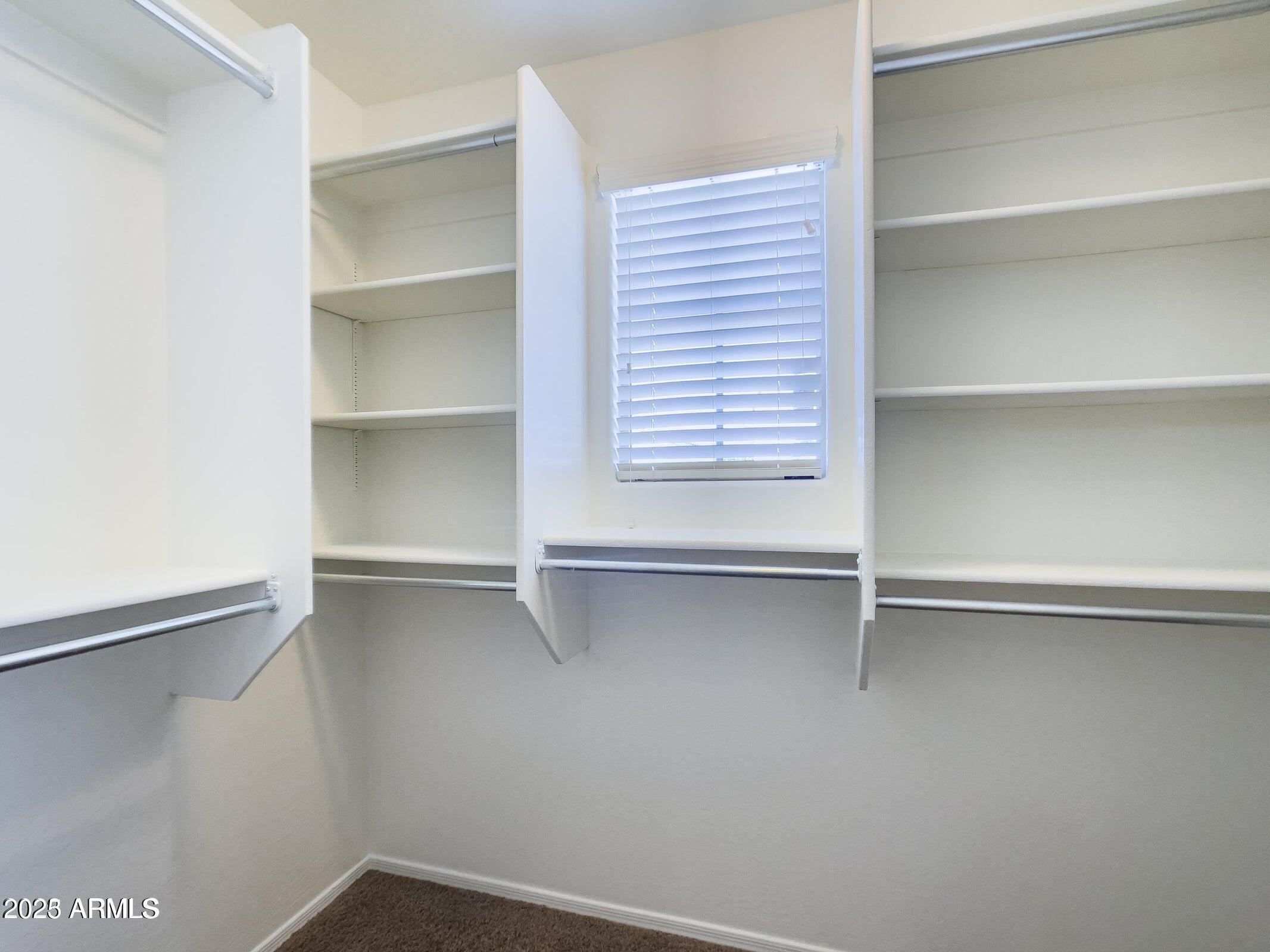 1958 West Busoni Place Phoenix, AZ 85023 - Photo 13 of 42 a view of walk in closet with empty racks