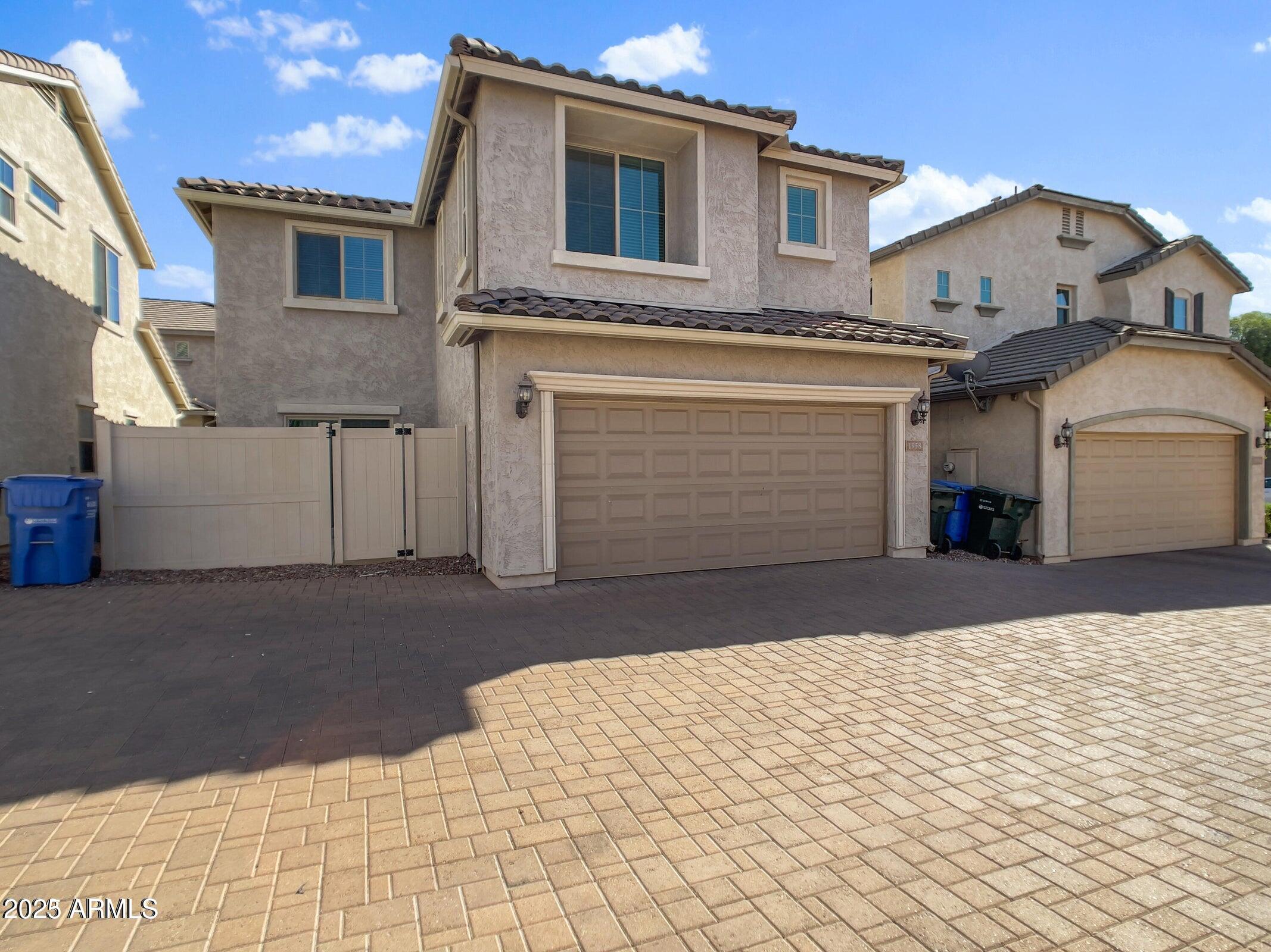 1958 West Busoni Place Phoenix, AZ 85023 - Photo 14 of 42 a front view of a house with a yard and garage