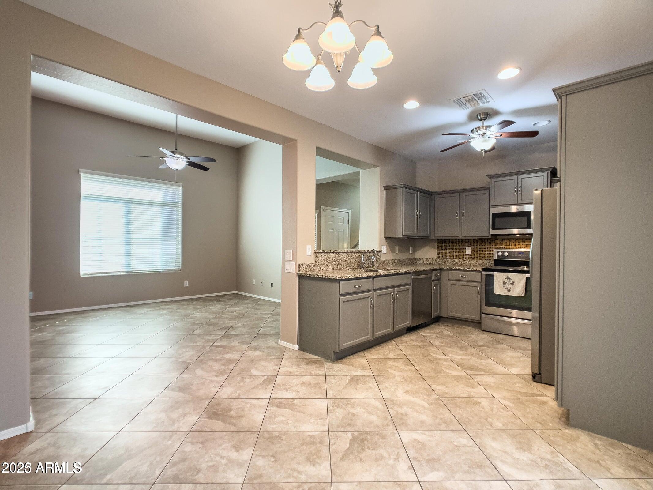1958 West Busoni Place Phoenix, AZ 85023 - Photo 29 of 42 a kitchen with a stove a sink cabinets and appliances