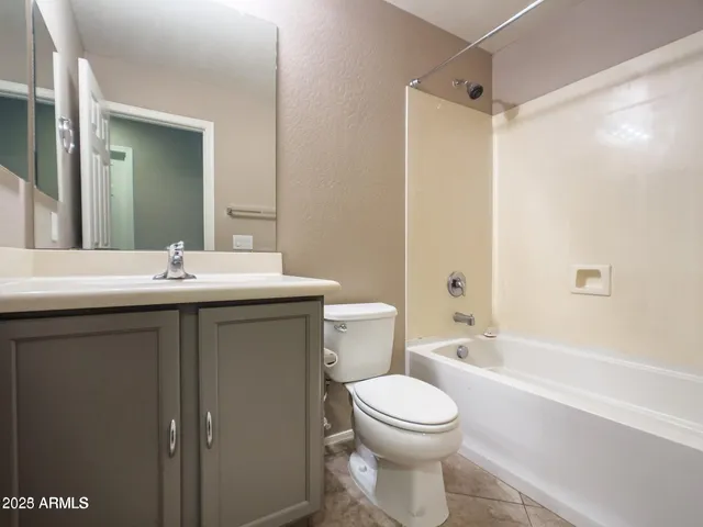 an empty room with a ceiling fan and fan