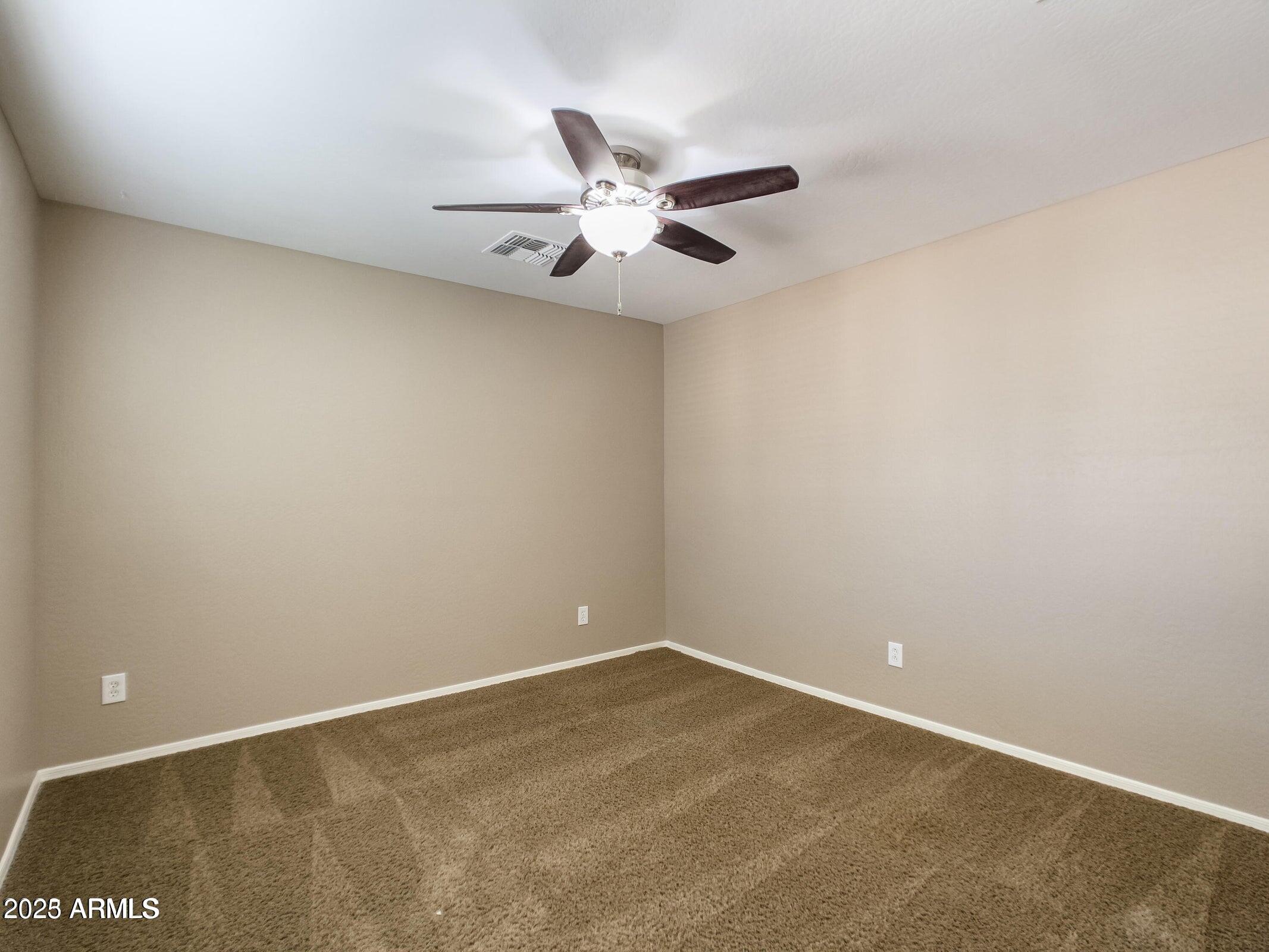 1958 West Busoni Place Phoenix, AZ 85023 - Photo 9 of 42 an empty room with a window and a ceiling fan