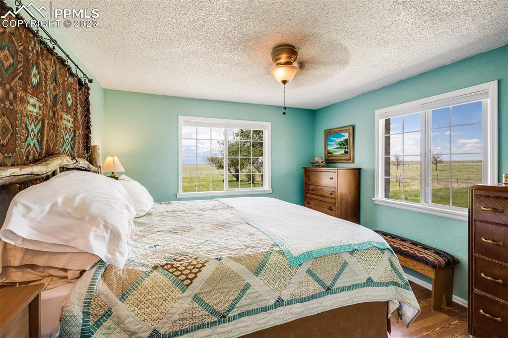 13490 South Lauppe Road Yoder, CO 80864 - Photo 11 of 45 a bed sitting in a bedroom next to a window