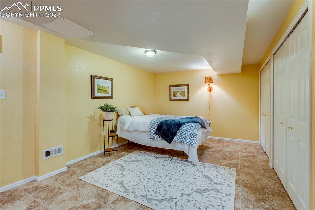 13490 South Lauppe Road Yoder, CO 80864 - Photo 16 of 45 a bedroom with a bed and wooden floor