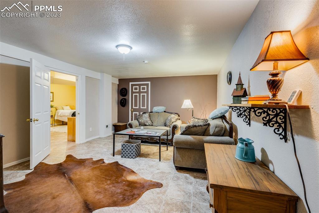 13490 South Lauppe Road Yoder, CO 80864 - Photo 17 of 45 a living room with furniture and a lamp