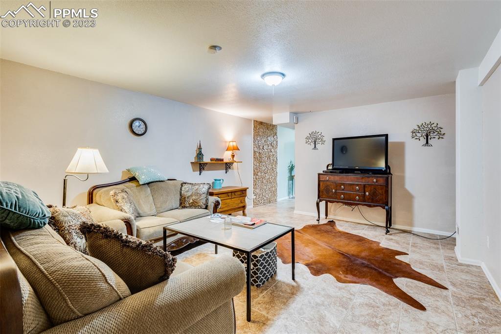 13490 South Lauppe Road Yoder, CO 80864 - Photo 18 of 45 a living room with furniture and a flat screen tv