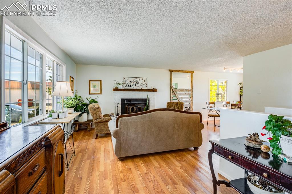 13490 South Lauppe Road Yoder, CO 80864 - Photo 2 of 45 a living room with furniture and a fireplace