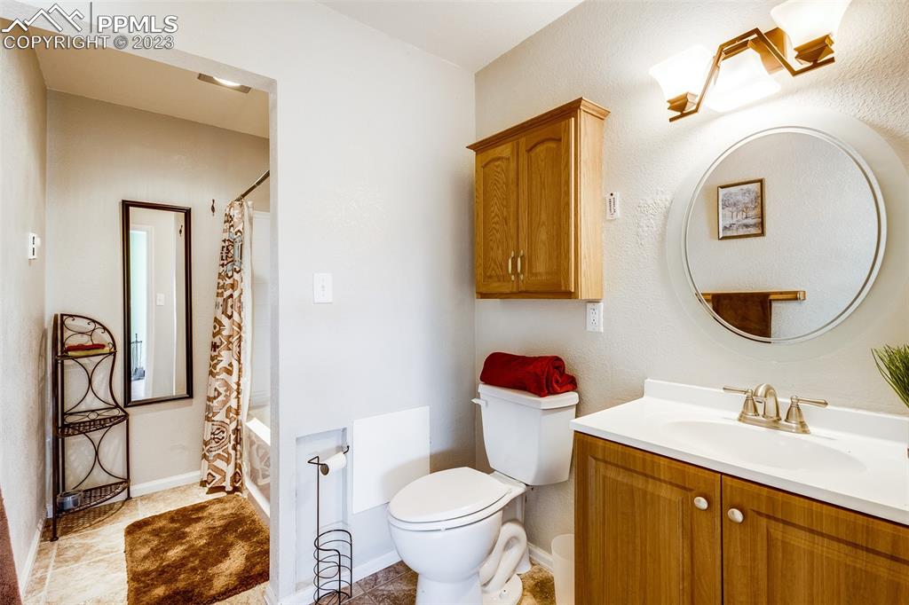 13490 South Lauppe Road Yoder, CO 80864 - Photo 24 of 45 a bathroom with a toilet sink and mirror