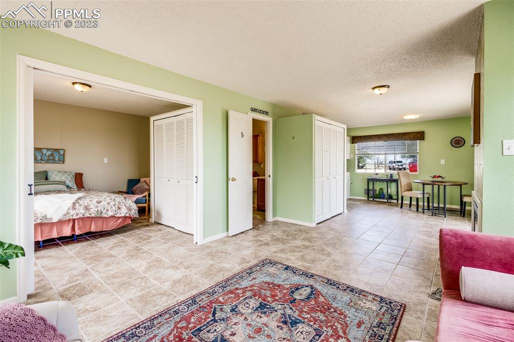 13490 South Lauppe Road Yoder, CO 80864 - Photo 26 of 45 a bedroom with furniture and a rug