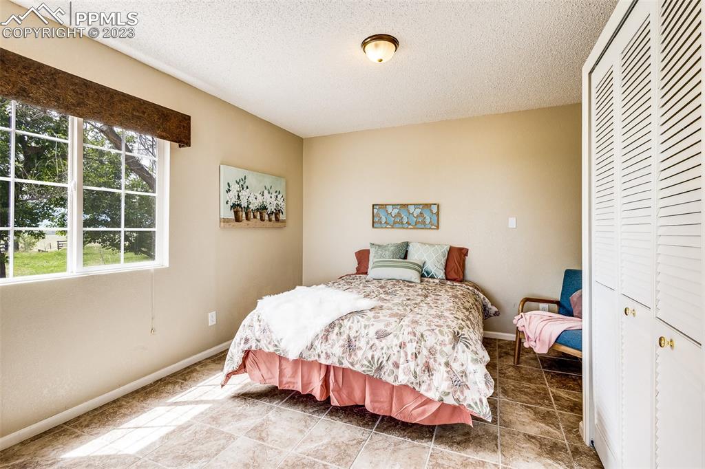 13490 South Lauppe Road Yoder, CO 80864 - Photo 27 of 45 a bedroom with a bed and a window