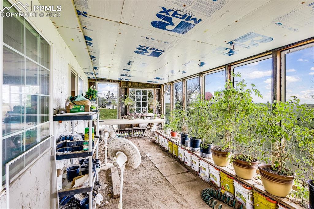 13490 South Lauppe Road Yoder, CO 80864 - Photo 31 of 45 a view of a porch with chairs and potted plants