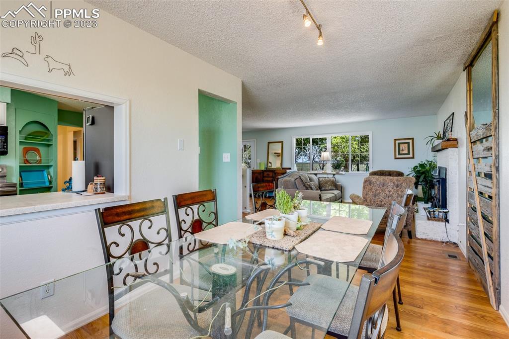 13490 South Lauppe Road Yoder, CO 80864 - Photo 5 of 45 a dining room with furniture a window and wooden floor