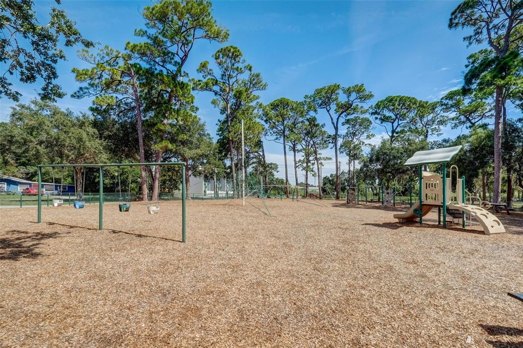 0 9th Street Sarasota, FL 34237 - Photo 16 of 16 a view of a park with swings and slides