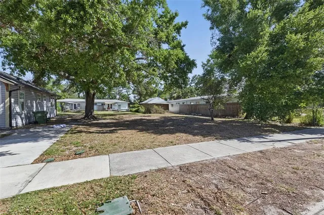 a view of street with with large trees