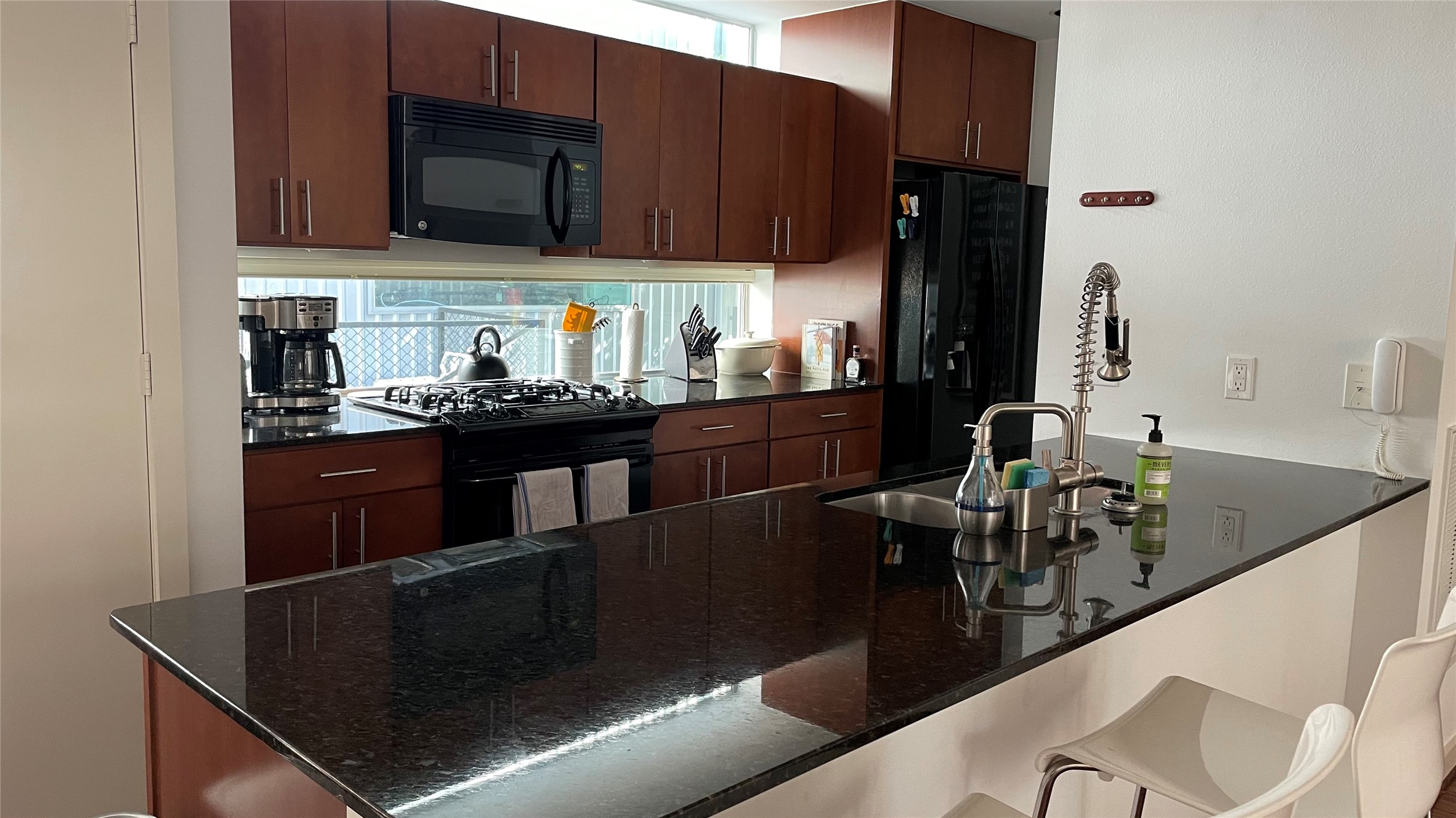 2918 Commerce Street Houston, TX 77003 - Photo 13 of 18 a kitchen with a sink cabinets and black stainless steel appliances