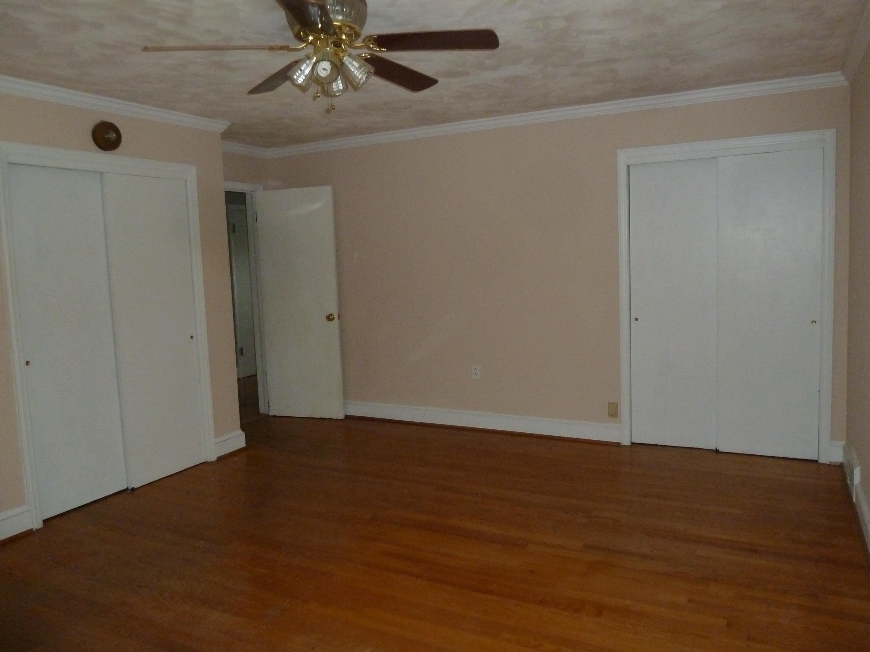 13692 West Gretna Road Sandy Level, VA 24161 - Photo 17 of 58 a view of an empty room with wooden floor and a ceiling fan