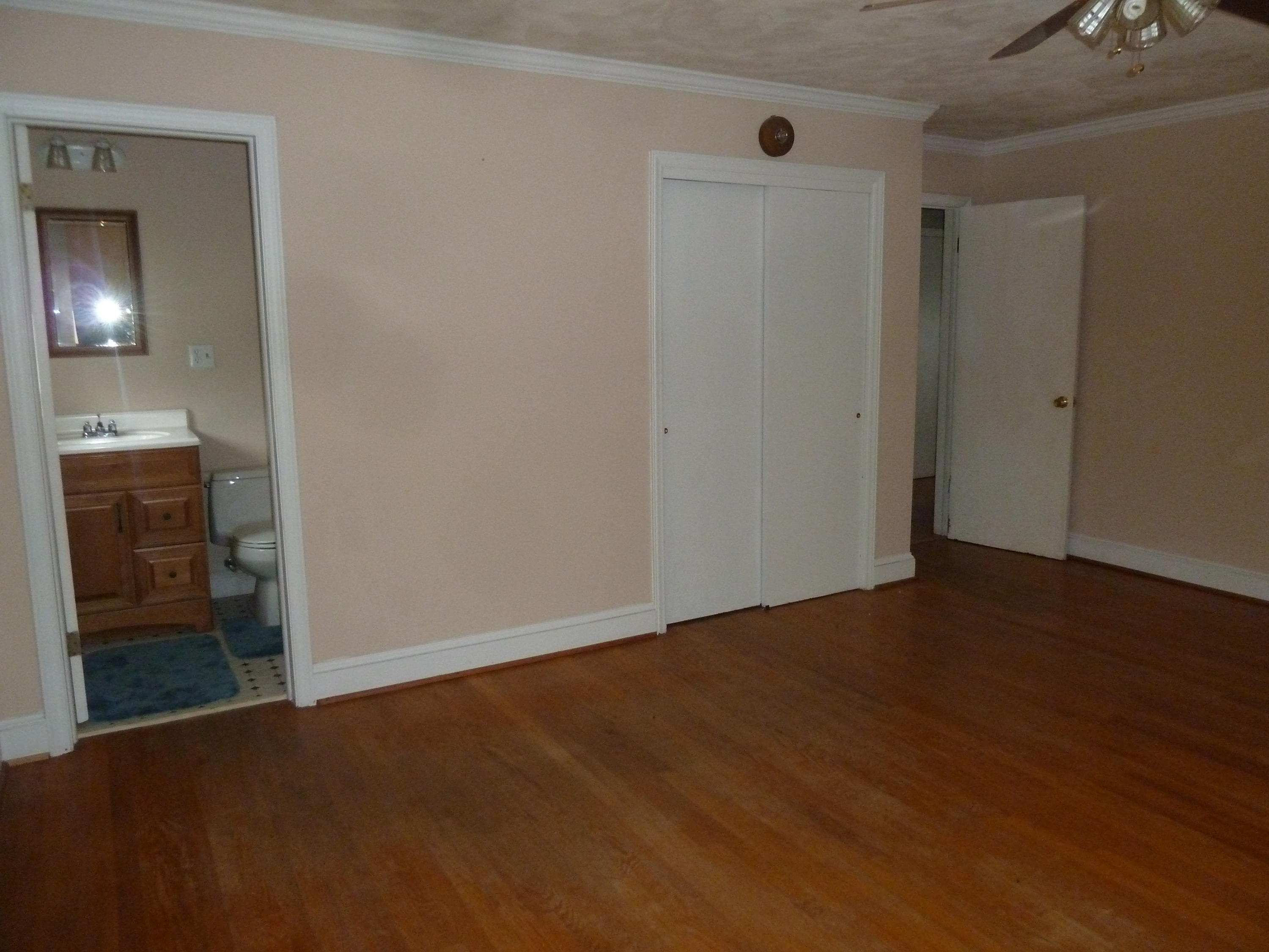 13692 West Gretna Road Sandy Level, VA 24161 - Photo 18 of 58 a view of an empty room with wooden floor and a bathroom