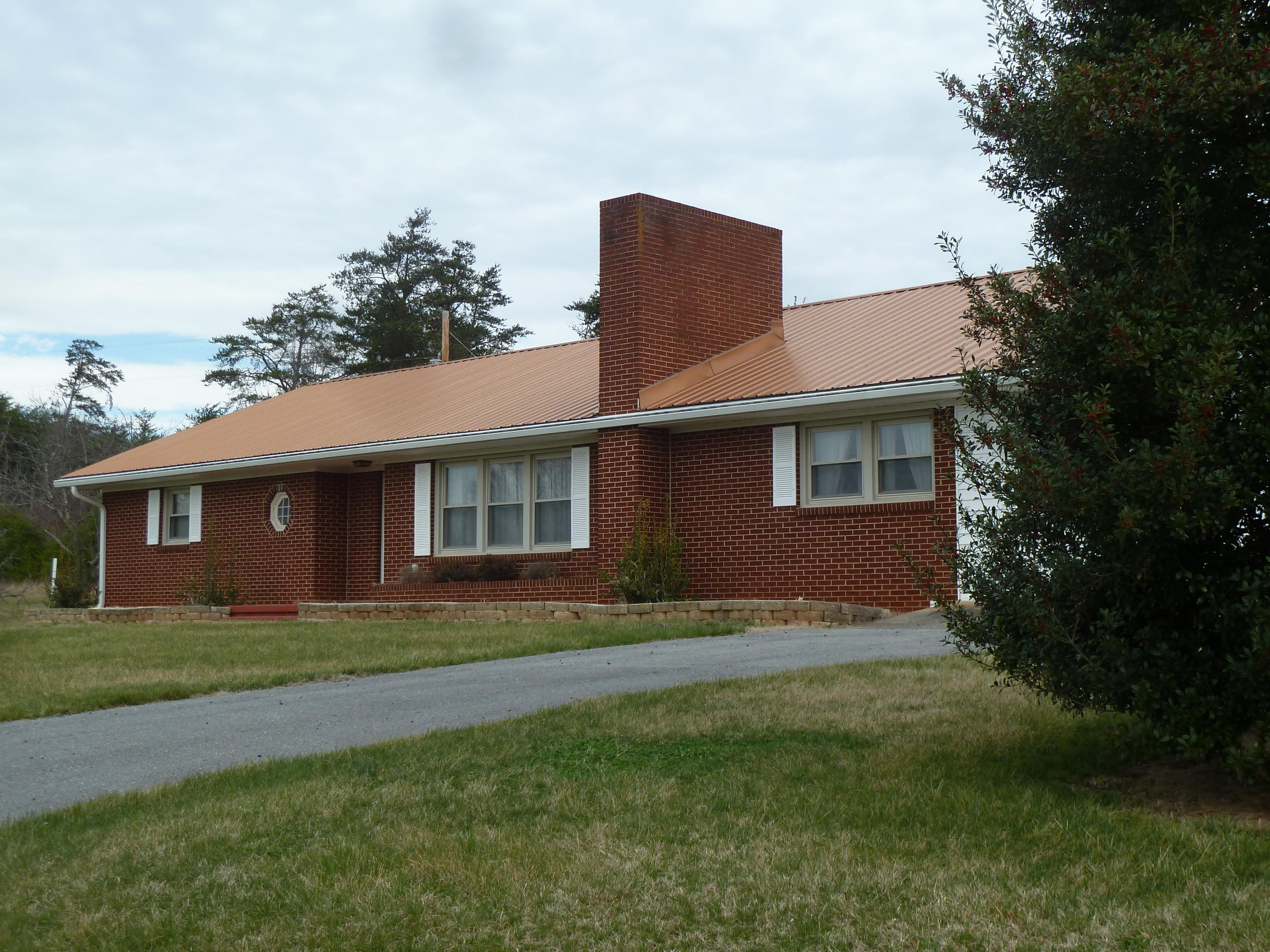13692 West Gretna Road Sandy Level, VA 24161 - Photo 30 of 58 a front view of house with yard and trees in the background