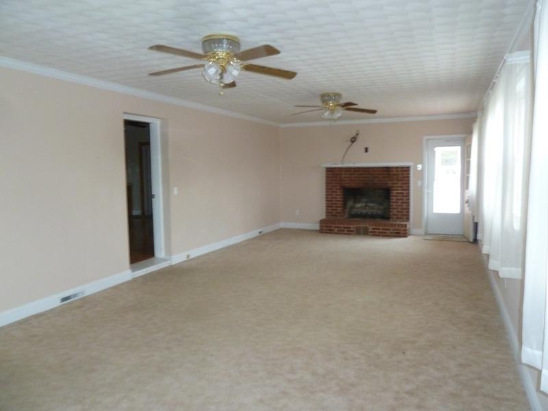 13692 West Gretna Road Sandy Level, VA 24161 - Photo 35 of 58 an empty room with windows and fireplace