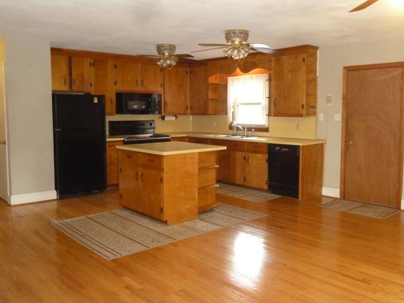 13692 West Gretna Road Sandy Level, VA 24161 - Photo 37 of 58 a kitchen with stainless steel appliances granite countertop a stove top oven a refrigerator a sink and dishwasher with wooden floor