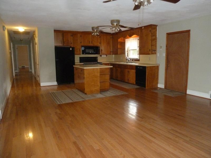 13692 West Gretna Road Sandy Level, VA 24161 - Photo 39 of 58 a kitchen with stainless steel appliances kitchen island granite countertop a stove a sink and a refrigerator