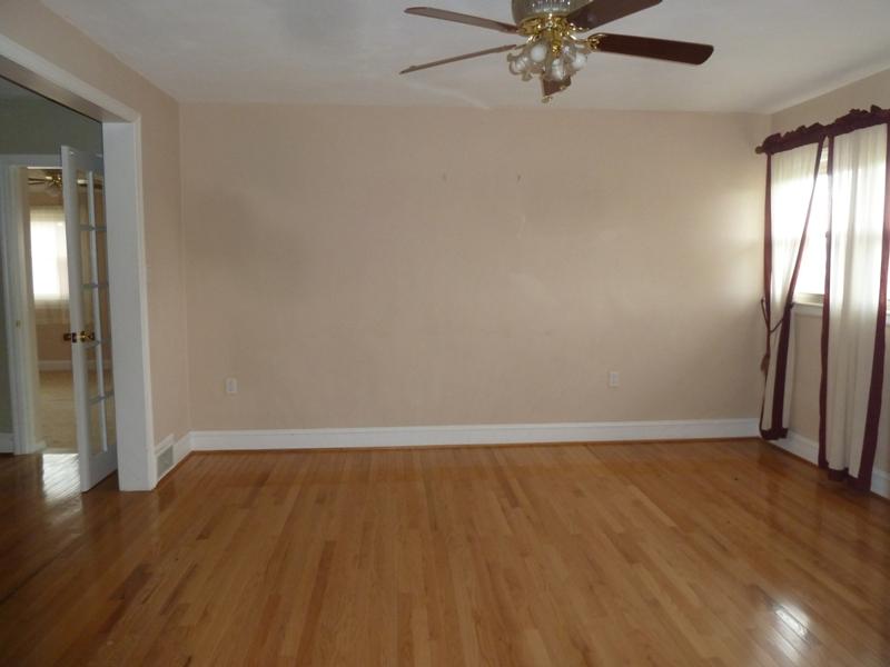 13692 West Gretna Road Sandy Level, VA 24161 - Photo 42 of 58 an empty room with wooden floor fan and windows
