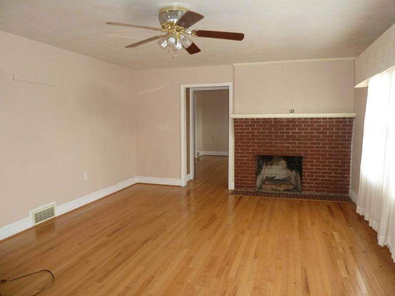 13692 West Gretna Road Sandy Level, VA 24161 - Photo 45 of 58 a view of empty room with wooden floor and fireplace