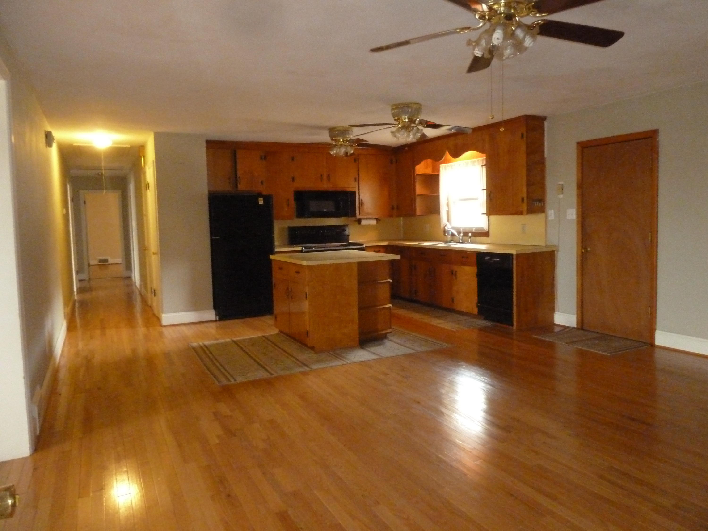 13692 West Gretna Road Sandy Level, VA 24161 - Photo 10 of 58 a kitchen with stainless steel appliances granite countertop a sink a stove cabinets and wooden floor