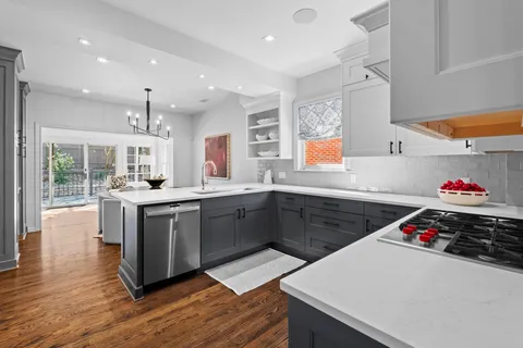 a dining room with furniture wooden floor a chandelier