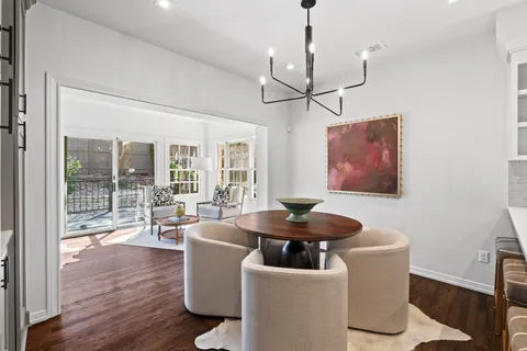 a living room with fireplace furniture and floor to ceiling windows