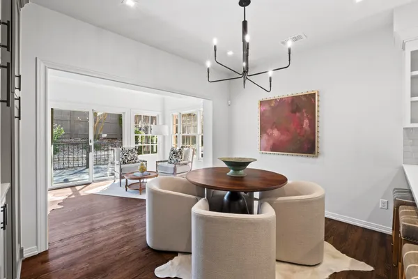 a living room with fireplace furniture and floor to ceiling windows