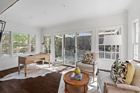 a living room with furniture and large window