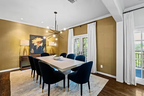 a view of a dining room with a table and chairs
